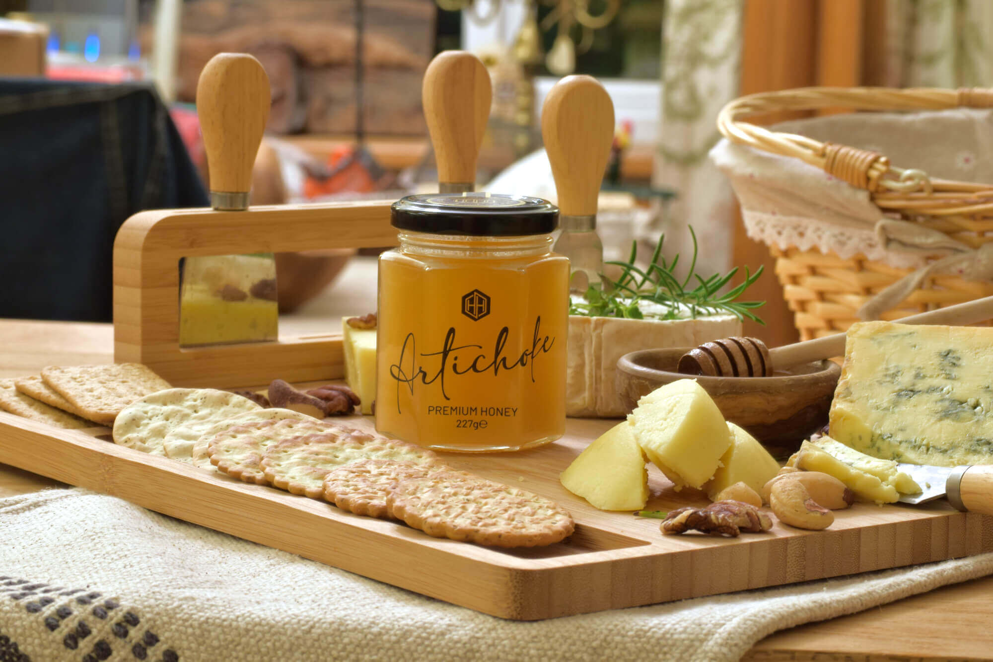 premium-artichoke-honey-227g-jar - Honey Hills - Online artisan shop with delicious, rare raw mountain honey varieties Jar of Mountain Artichoke Thistle Honey on a wooden platter with cheese, crackers, and nuts, showcasing its natural and refined taste.